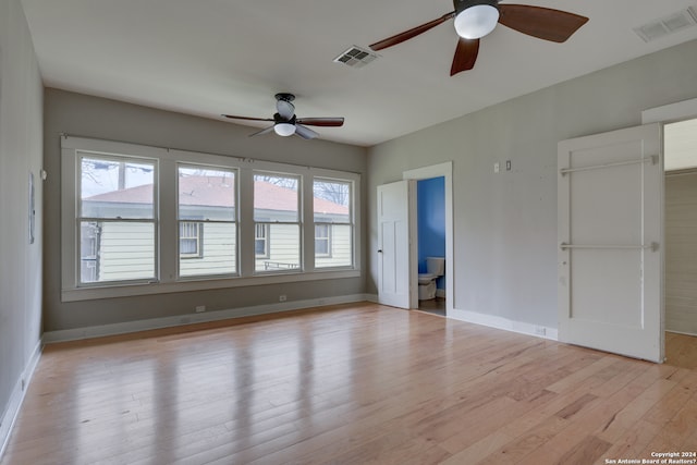 spare room with ceiling fan and light wood-type flooring