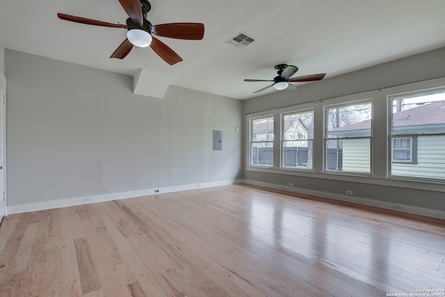 spare room with a wealth of natural light, light hardwood / wood-style flooring, and ceiling fan