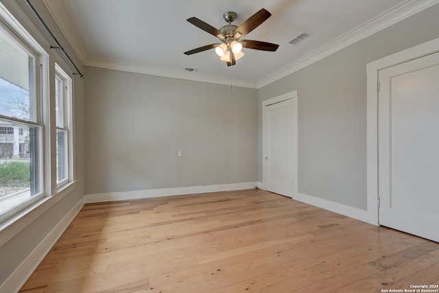 unfurnished room featuring ornamental molding, ceiling fan, and light wood-type flooring