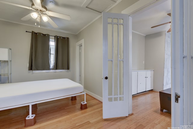 bedroom featuring ceiling fan, light hardwood / wood-style floors, and ornamental molding