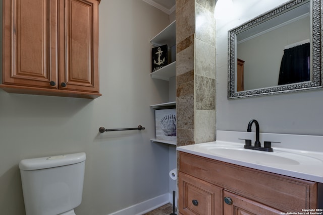 bathroom featuring ornamental molding, vanity, and toilet