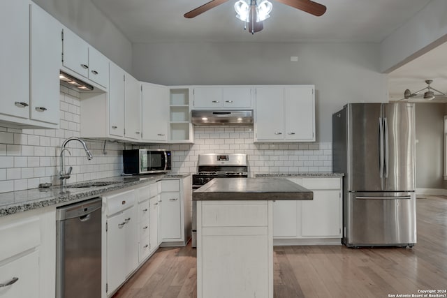 kitchen featuring white cabinets, ceiling fan, stainless steel appliances, and a kitchen island