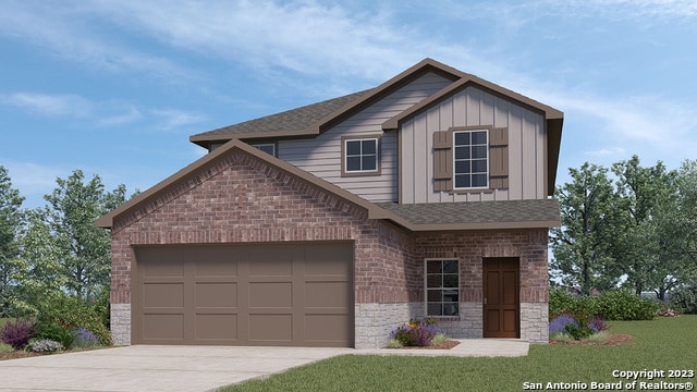 view of front of property featuring a garage and a front lawn