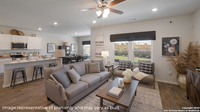 living room with ceiling fan and dark hardwood / wood-style flooring