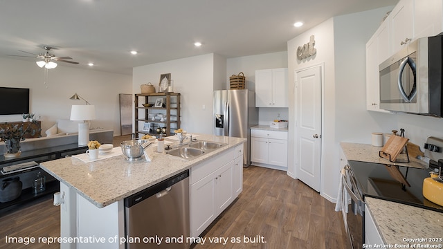 kitchen with white cabinets, stainless steel appliances, and a kitchen island with sink