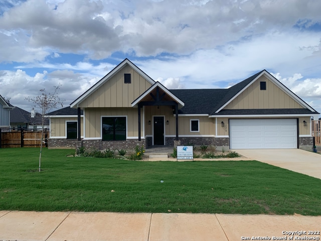 craftsman-style house featuring a front yard and a garage