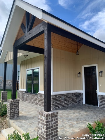 entrance to property with a patio