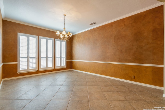 spare room with ornamental molding, a notable chandelier, and light tile floors