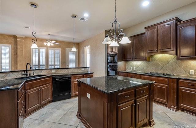 kitchen featuring a center island, decorative light fixtures, ceiling fan with notable chandelier, black appliances, and sink