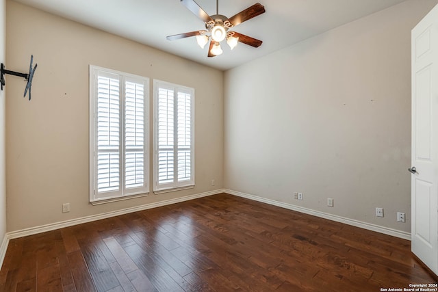 empty room with ceiling fan and dark wood-type flooring