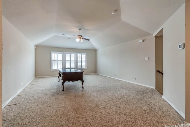 interior space featuring light carpet, ceiling fan, and vaulted ceiling