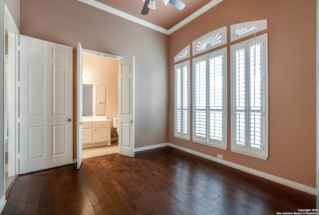 unfurnished bedroom with crown molding, ensuite bath, dark hardwood / wood-style flooring, and ceiling fan