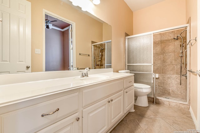 bathroom featuring an enclosed shower, vanity, ceiling fan, tile flooring, and toilet