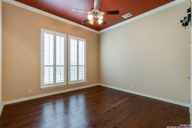 empty room featuring dark hardwood / wood-style floors, ceiling fan, and ornamental molding