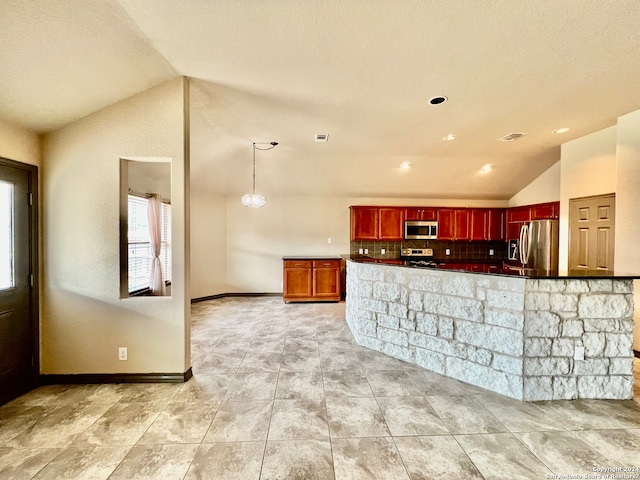 kitchen featuring light tile floors, hanging light fixtures, appliances with stainless steel finishes, backsplash, and lofted ceiling