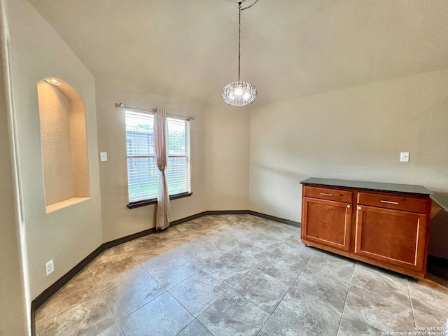 empty room featuring a notable chandelier, high vaulted ceiling, and light tile floors