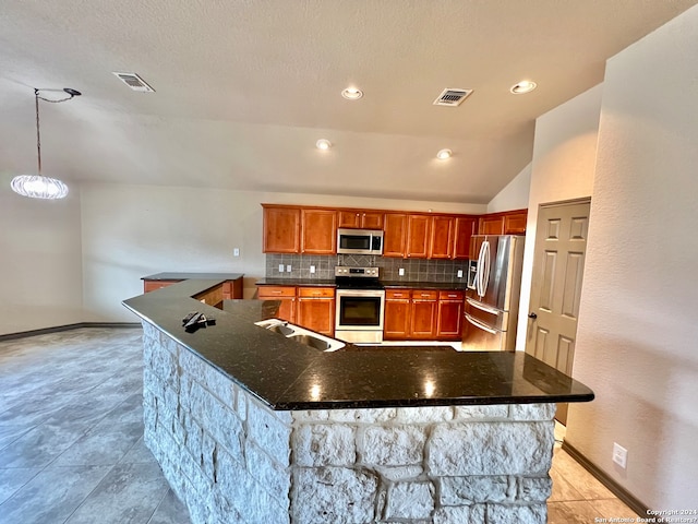 kitchen with backsplash, a notable chandelier, stainless steel appliances, a kitchen island, and pendant lighting