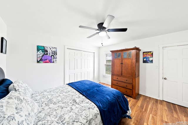 bedroom with a closet, light hardwood / wood-style floors, and ceiling fan