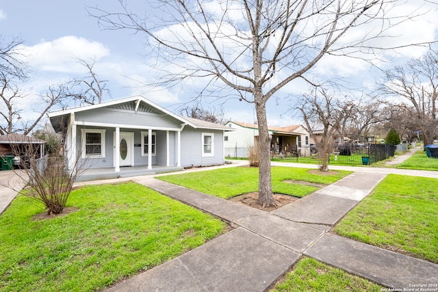 bungalow-style home with a front yard and a porch