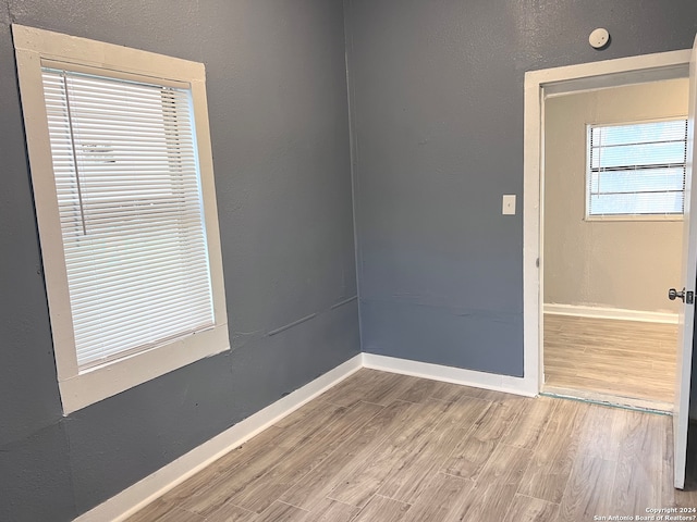 unfurnished room with light hardwood / wood-style floors