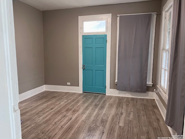 empty room featuring dark hardwood / wood-style floors and plenty of natural light