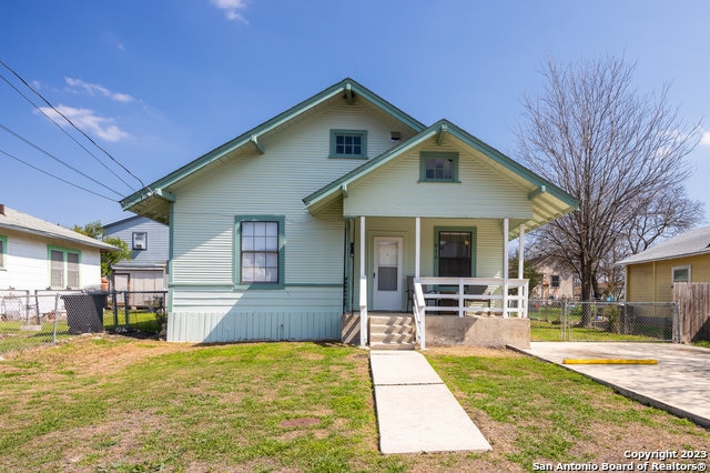 bungalow with a porch and a front yard