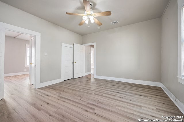 unfurnished room with ceiling fan and light wood-type flooring