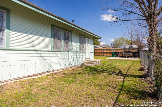 exterior space with a lawn and a patio