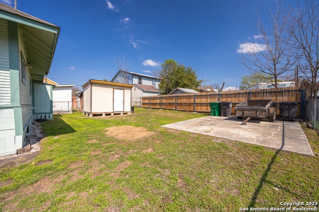 view of yard with a patio and a shed