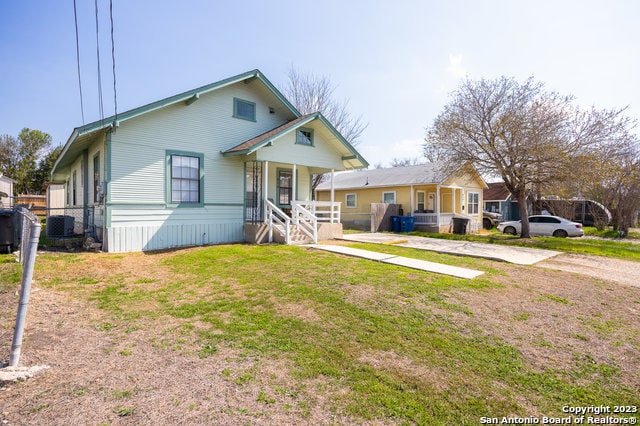 view of front of home with a porch and a front yard