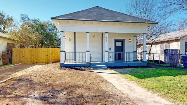 bungalow-style home featuring covered porch and a front yard