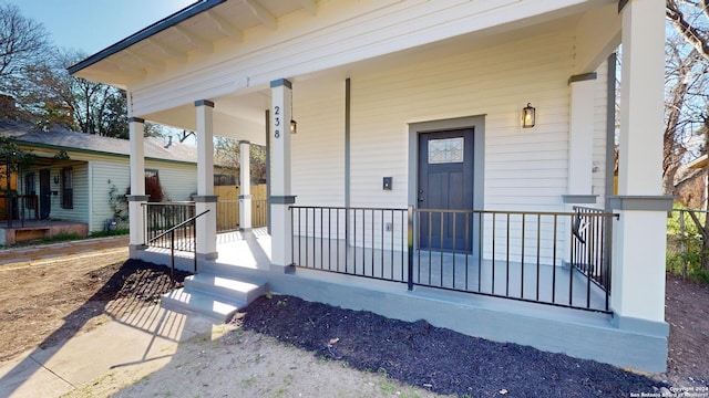 view of exterior entry featuring a porch