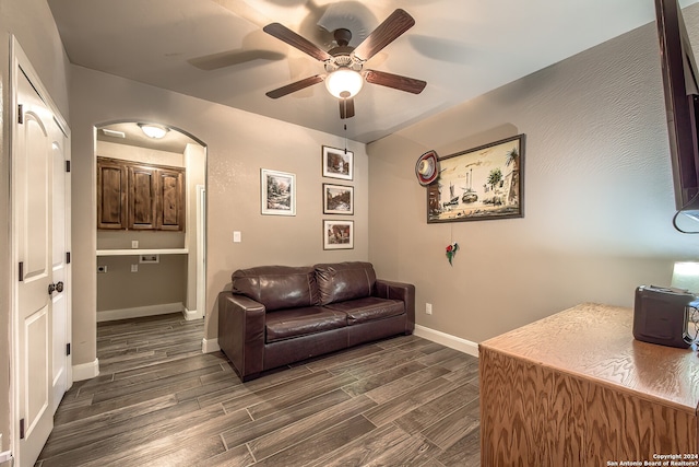 home office with ceiling fan and dark hardwood / wood-style floors