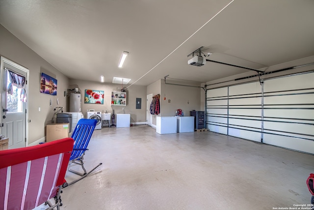 garage with electric water heater, a garage door opener, and washing machine and dryer