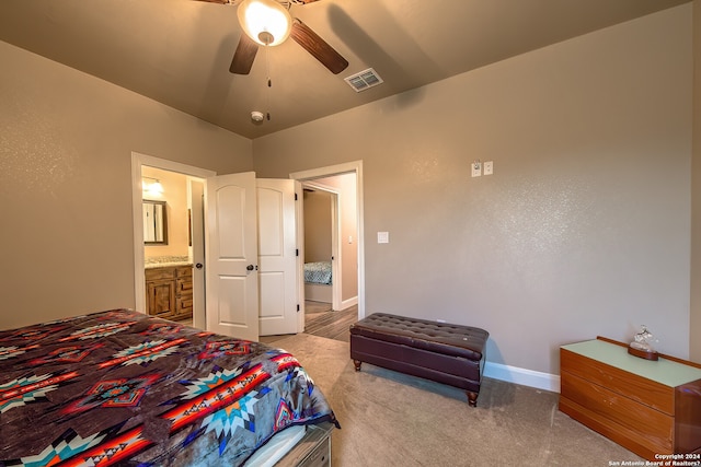 carpeted bedroom featuring ensuite bathroom and ceiling fan