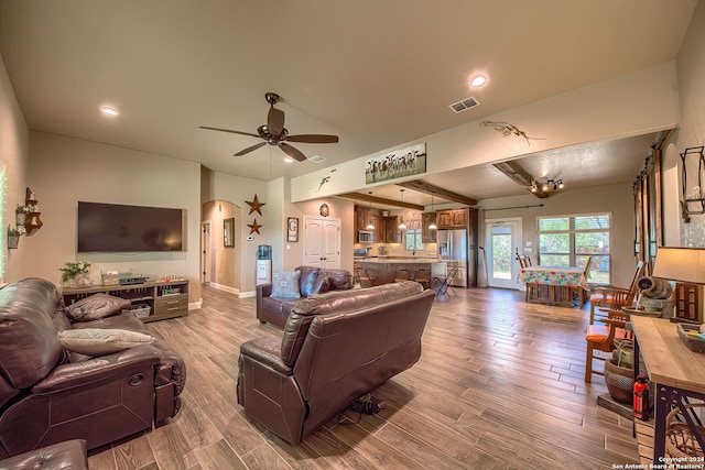 living room with hardwood / wood-style floors and ceiling fan