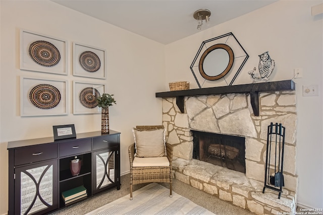 sitting room featuring light carpet and a fireplace