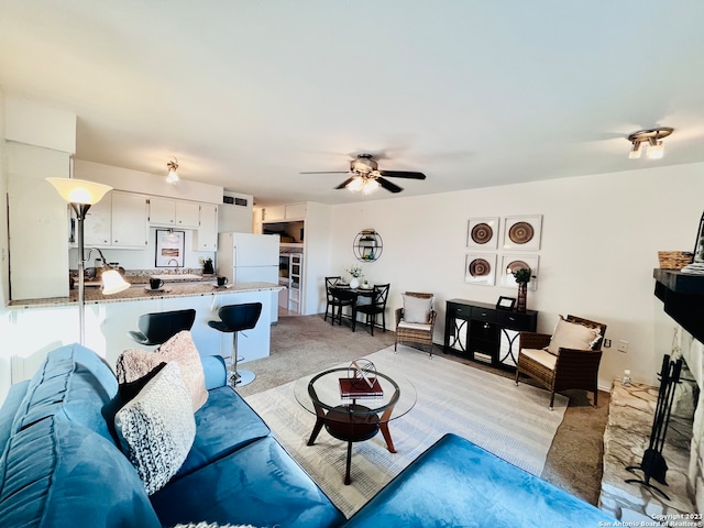 living room with light carpet and ceiling fan