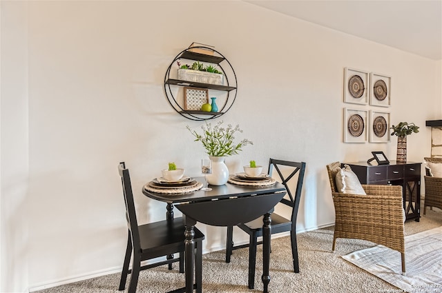 dining area featuring light colored carpet