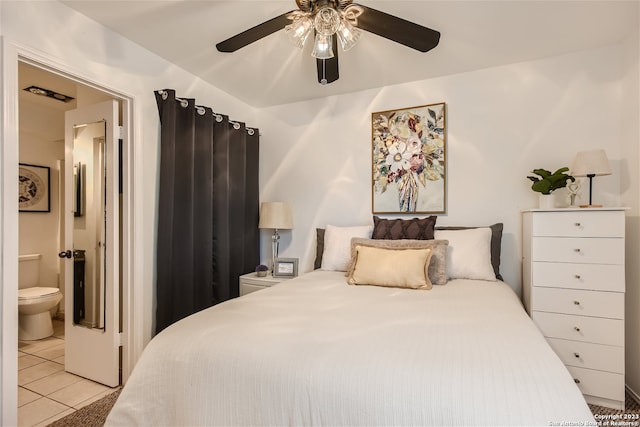 tiled bedroom featuring ceiling fan and ensuite bathroom