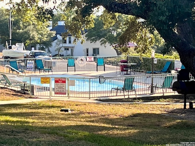 exterior space with a pool and a yard