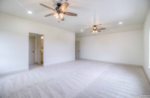 unfurnished room with ceiling fan and light colored carpet