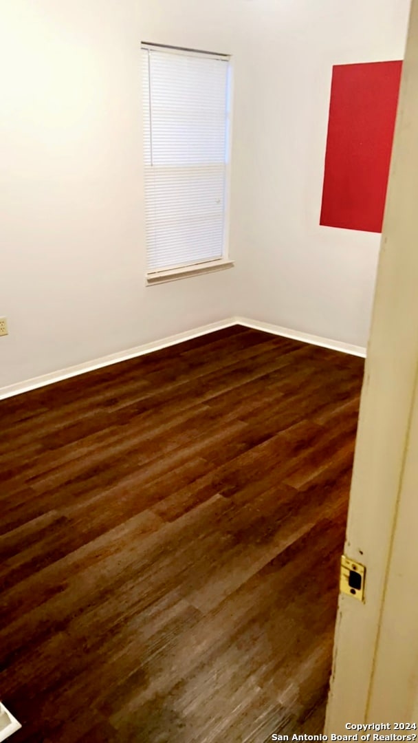 unfurnished room featuring dark hardwood / wood-style floors