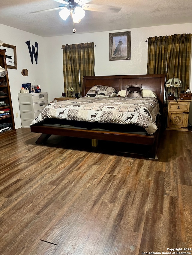 bedroom with ceiling fan and dark wood-type flooring