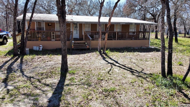 rear view of house with covered porch