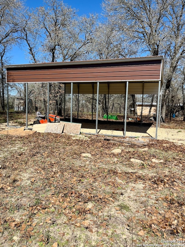 back of house with a carport