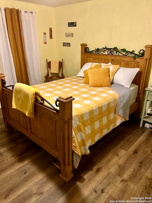 bedroom with dark wood-type flooring