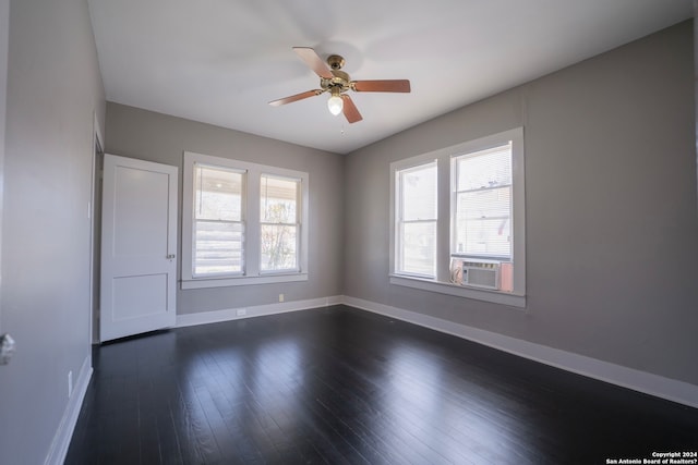 spare room featuring plenty of natural light, dark hardwood / wood-style flooring, and ceiling fan