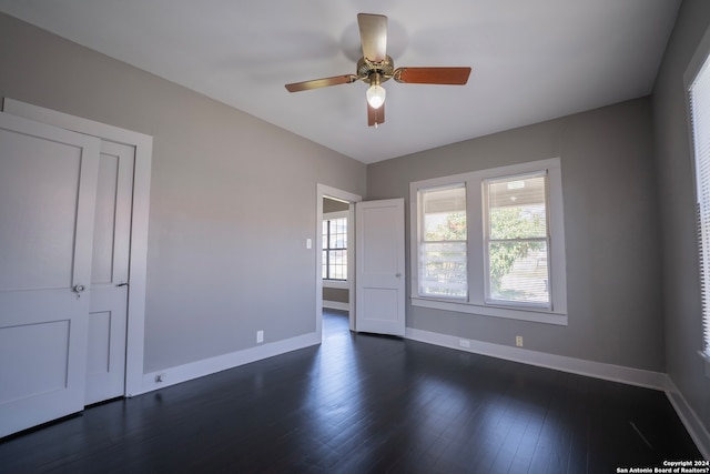 unfurnished room with ceiling fan and dark hardwood / wood-style floors