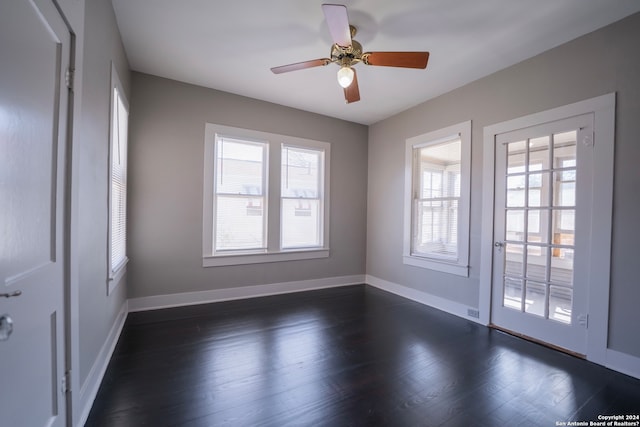 empty room featuring ceiling fan and dark hardwood / wood-style flooring